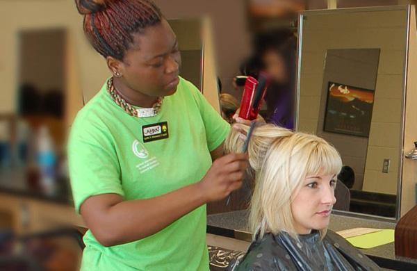Student getting hair styled at Transitions School of Cosmetology